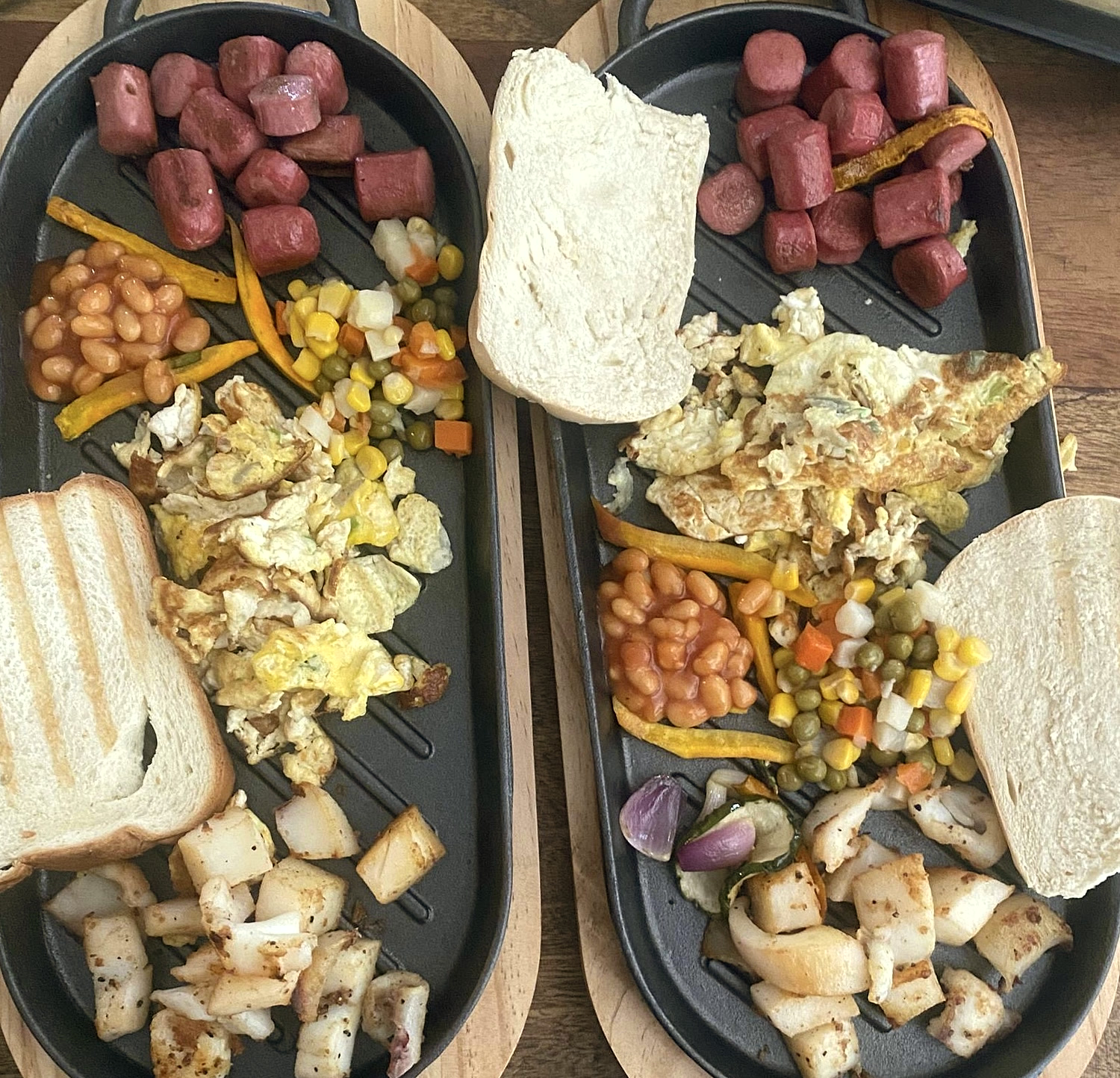 Breakfast at Marsaiah on cast-iron platters — eggs, sausage, beans, garden vegetables and toast